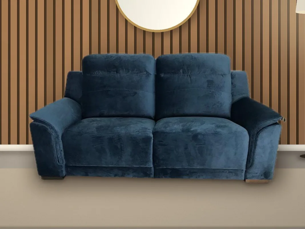 Catalogue image: the blue sofa in a room with a slatted wood wall and a round mirror