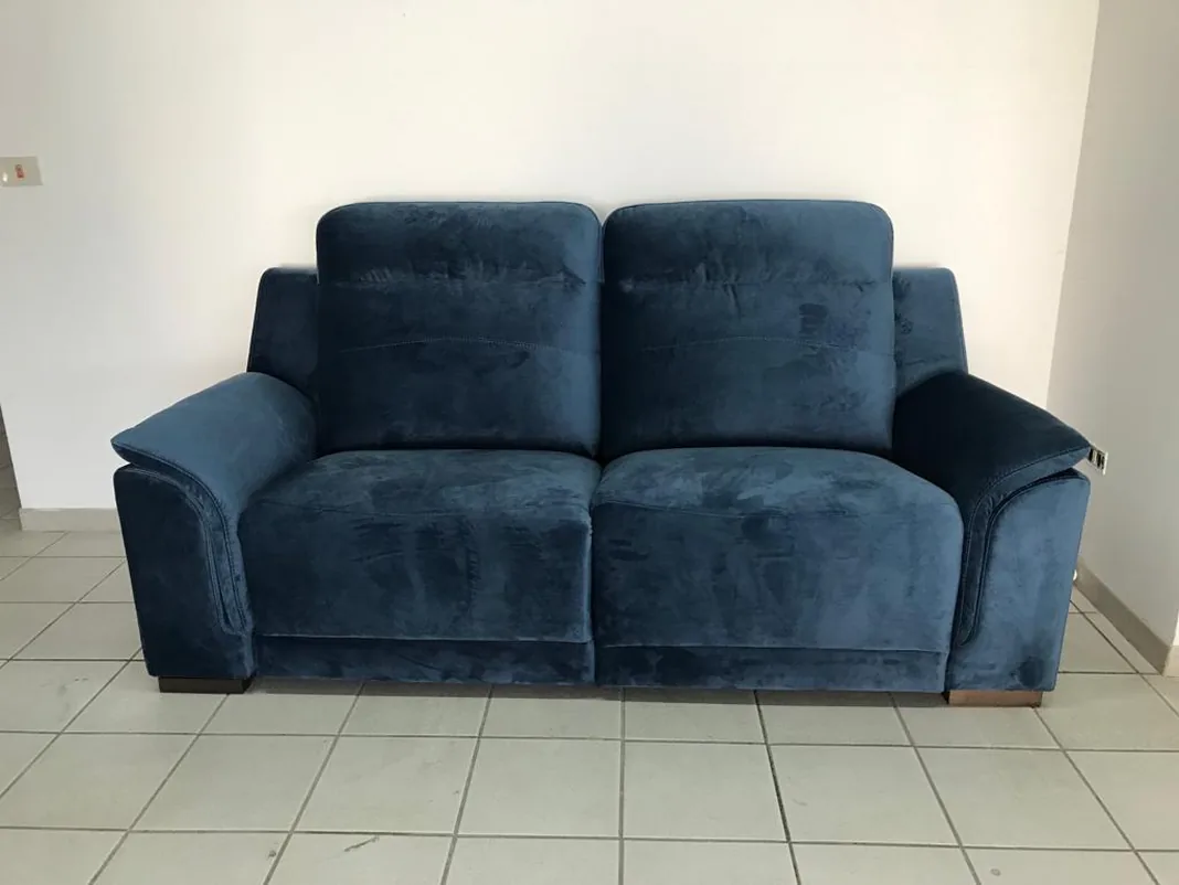 Original photo: the same blue sofa on the tiled workshop floor